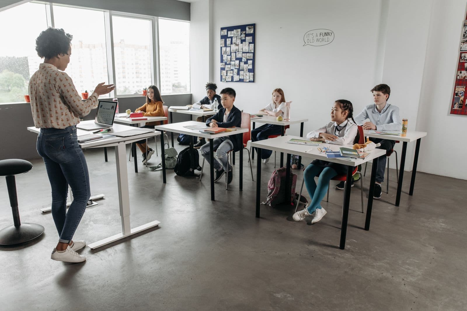A teacher teaching engaged students in a bright classroom