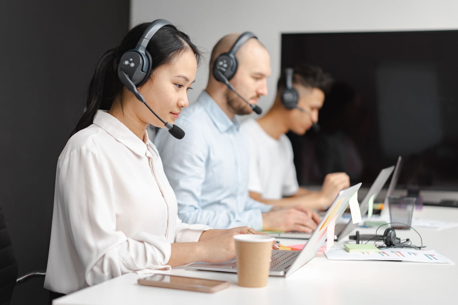 A customer-service team wearing headsets